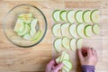 WomanÃ¢â¬â¢s hands taking granny smith apple slices out of a glass bowl and laying them out on a mesh tray for dehydrating Royalty Free Stock Photo